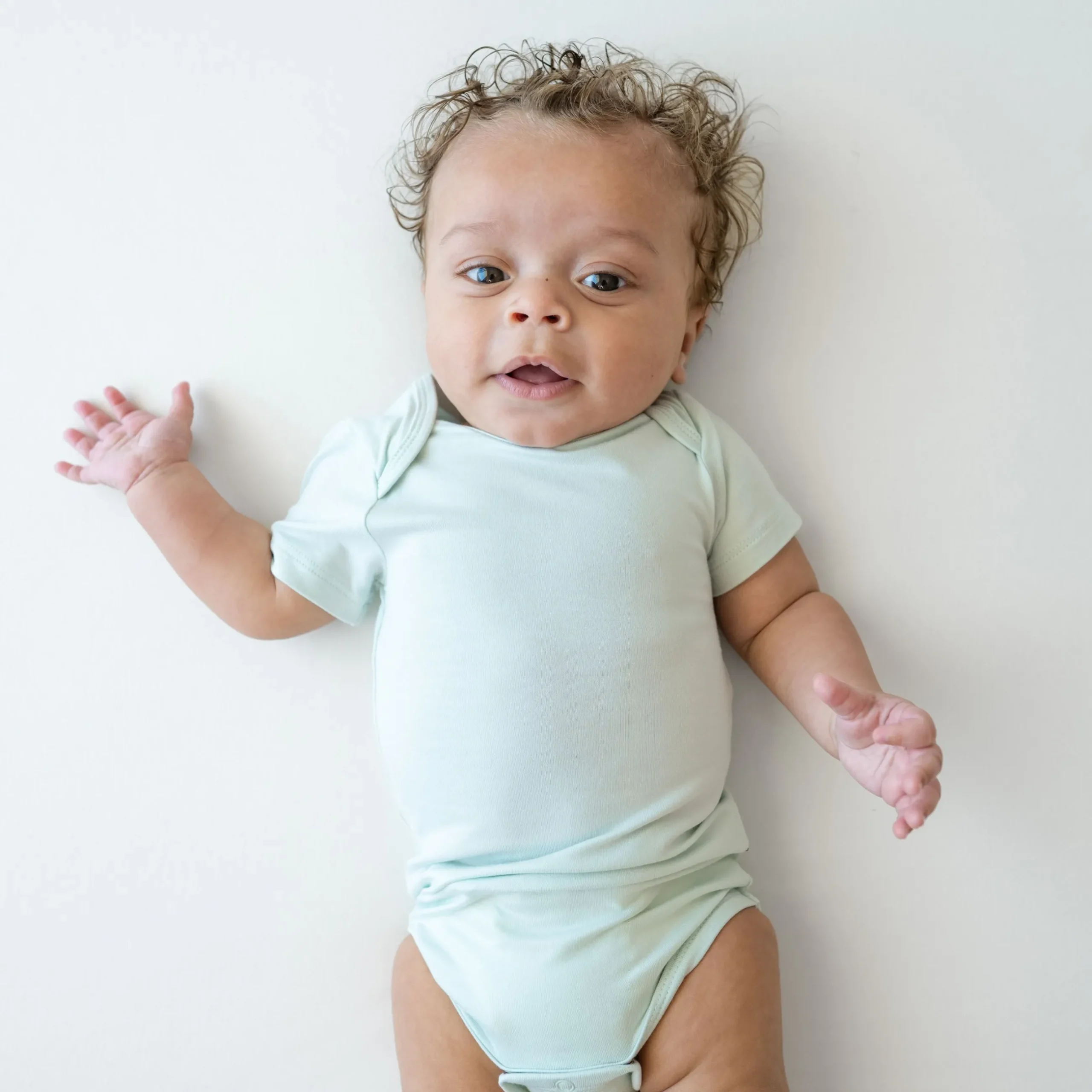 Sale Kyte Baby Bodysuit in Dew