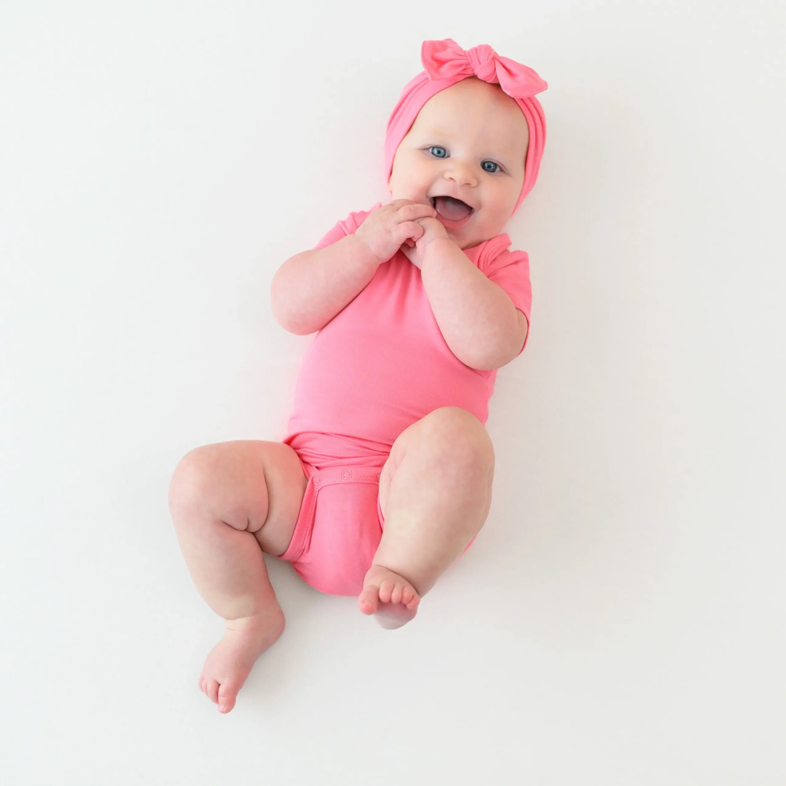 Kyte Baby Bodysuit in Guava