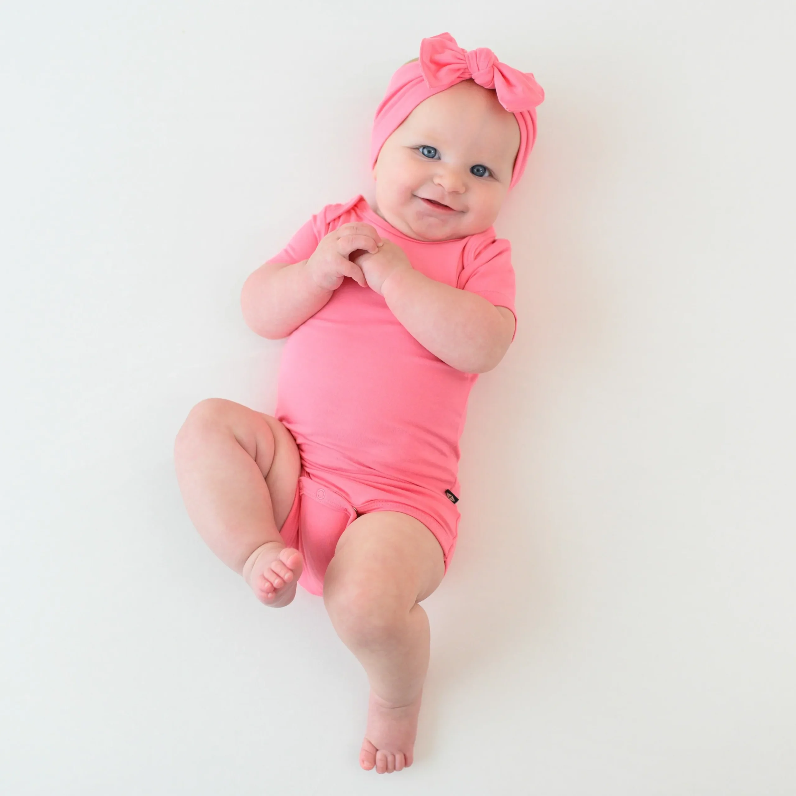 Kyte Baby Bodysuit in Guava