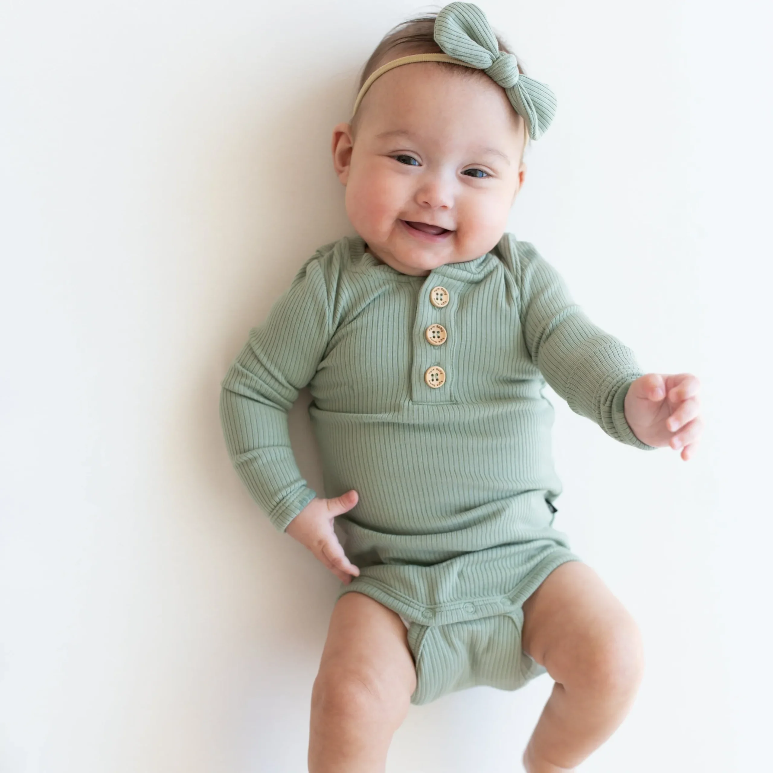 Kyte Baby Ribbed Long Sleeve Henley Bodysuit in Thyme