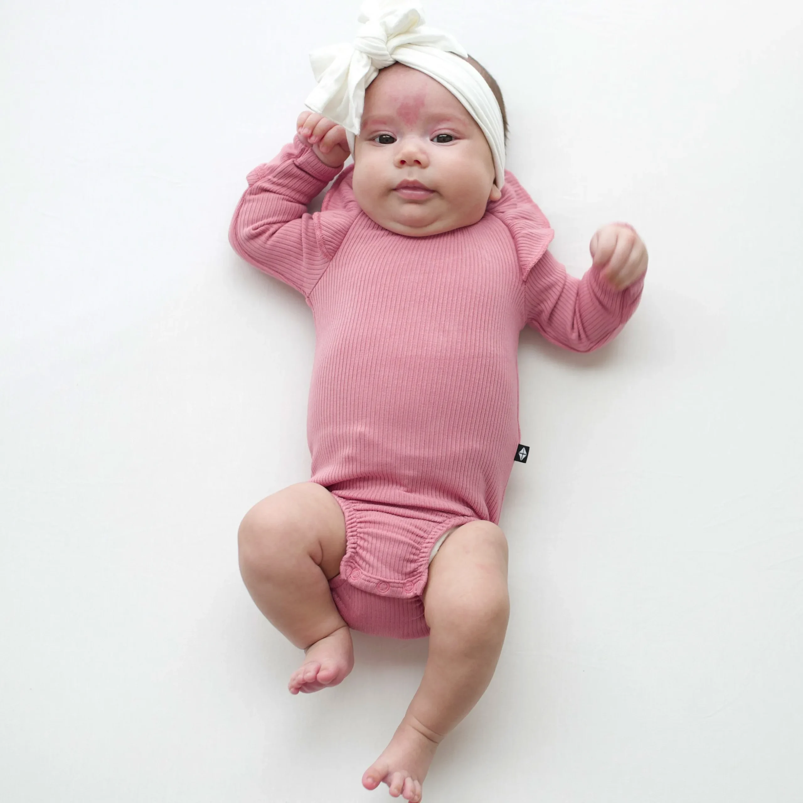 New Kyte Baby Ribbed Long Sleeve Ruffle Leotard in Apple Blossom