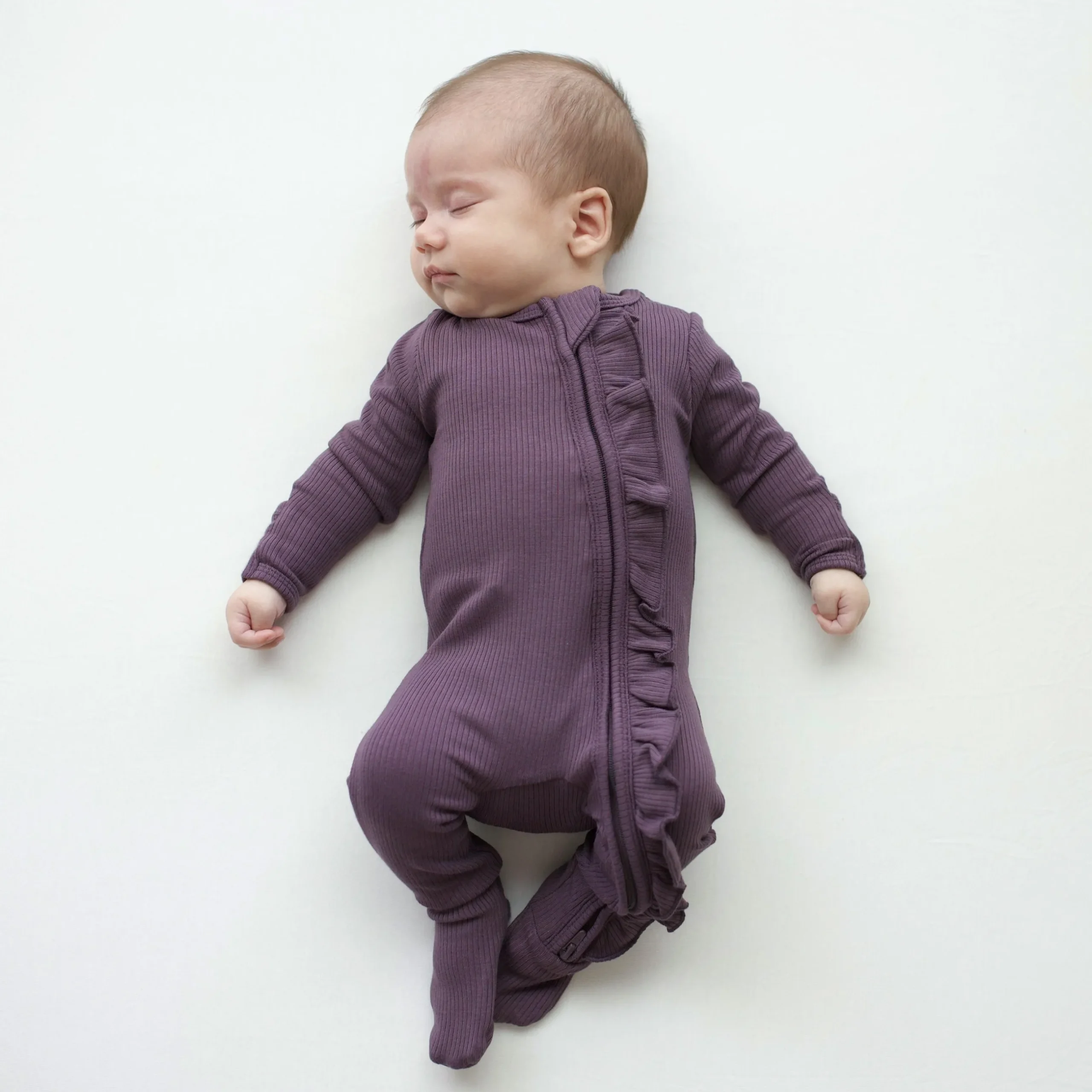 Kyte Baby Ribbed Ruffle Zipper Footie in Currant