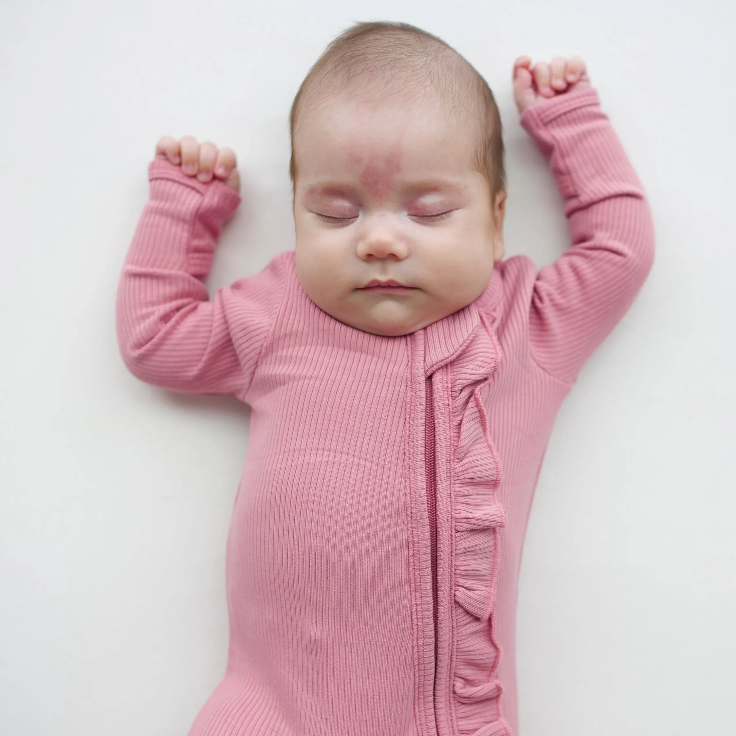 New Kyte Baby Ribbed Ruffle Zipper Footie in Apple Blossom