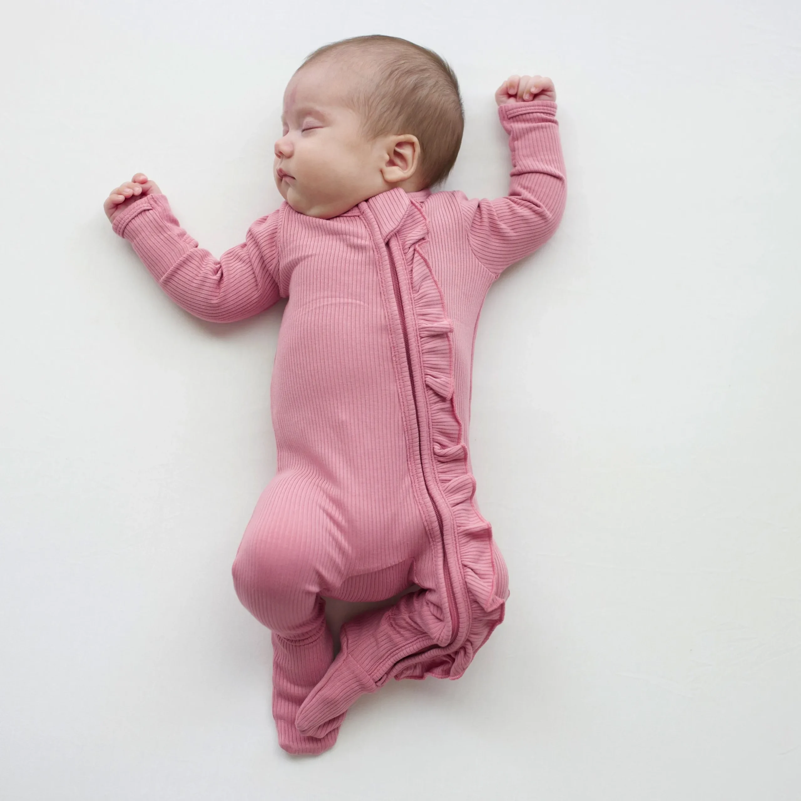 New Kyte Baby Ribbed Ruffle Zipper Footie in Apple Blossom