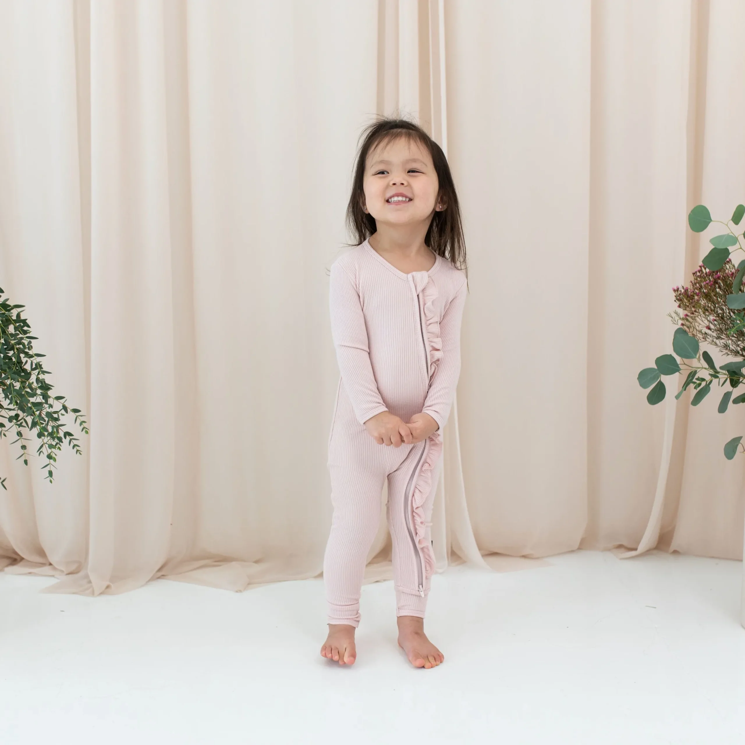 Clearance Kyte Baby Ribbed Ruffle Zipper Romper in Blush