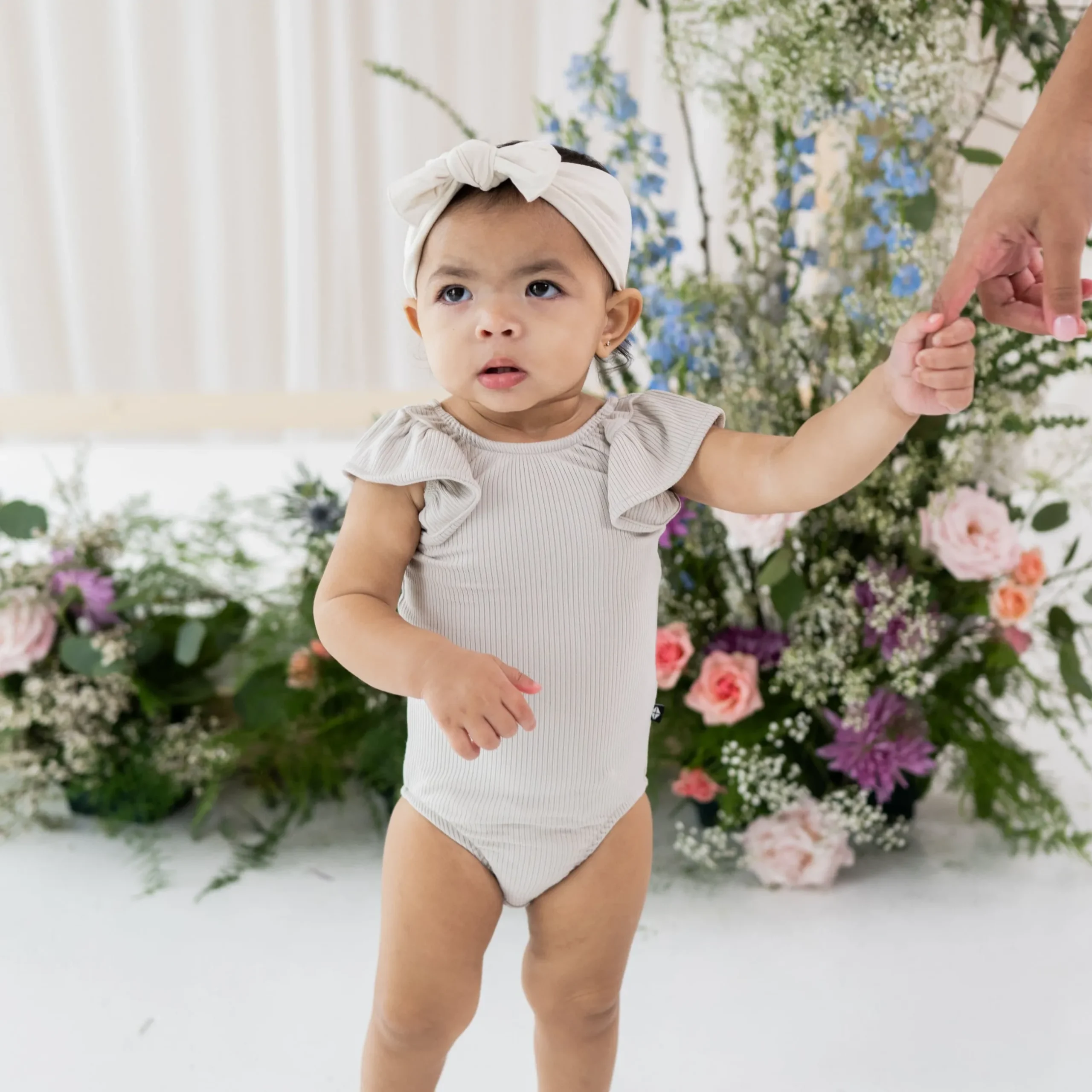 Kyte Baby Ribbed Sleeveless Ruffle Leotard in Oat